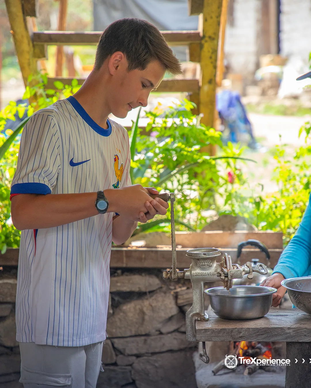Boy grinding coffee in Santa Teresa Boy grinding coffee in Santa Teresa - Salkantay Trek Guide | TreXperience